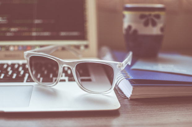 Sunglasses on desk by Caio Resende via StockSnap